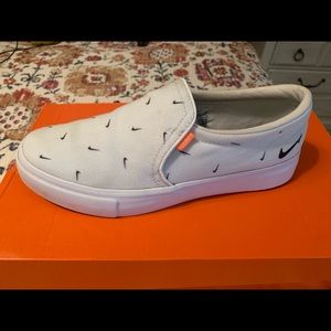 Nike white slip ons. Worn once or twice. SiZe 7